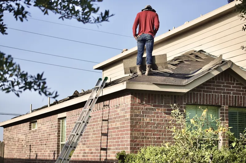 Professional roofer working on a residential roof in Brownville